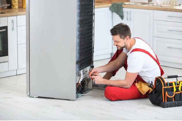 Technician fixing ice maker issue
